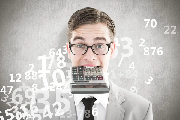 Geeky smiling businessman biting calculator — Stock Photo, Image