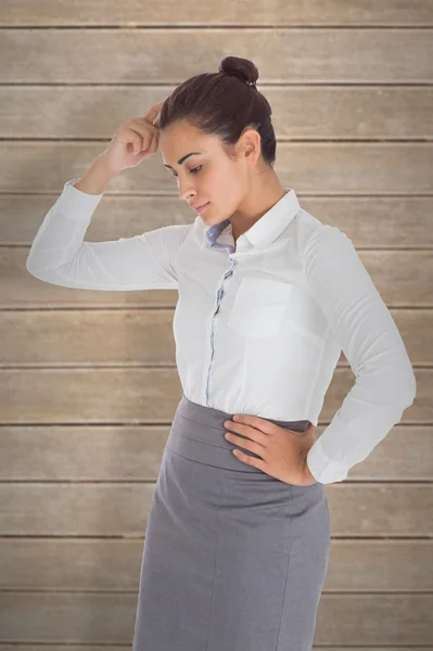 Focused businesswoman against wooden planks — Stock Photo, Image