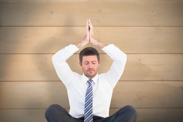 Businessman meditating in lotus pose — Stock Photo, Image