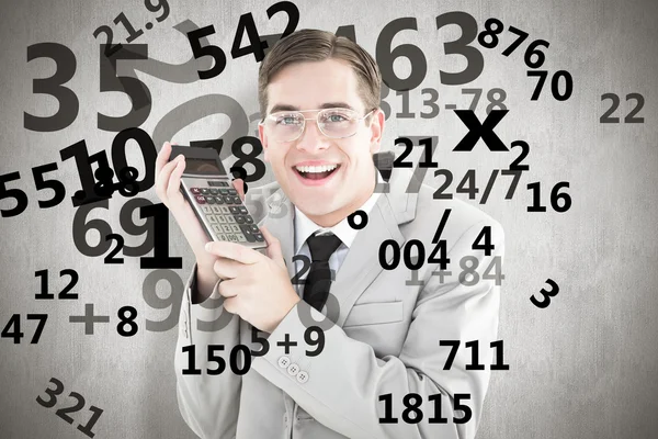 Geeky smiling businessman holding calculator — Stock Photo, Image