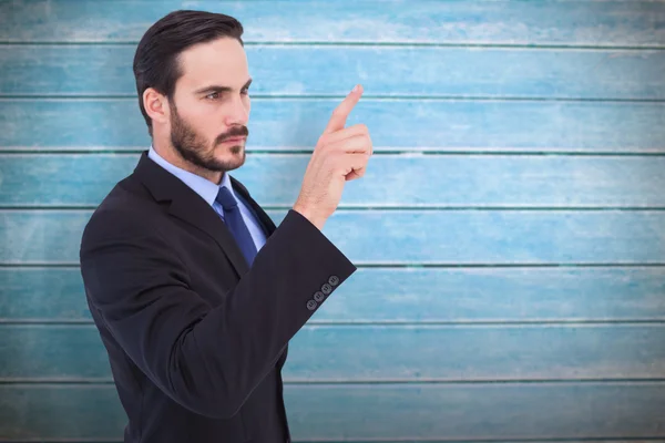 Focused businessman pointing in suit jacket — Stock Photo, Image