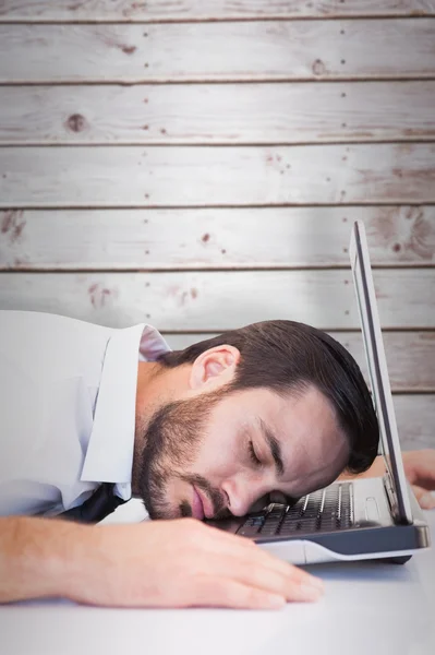 Businessman resting head on laptop keyboard — Stock Photo, Image