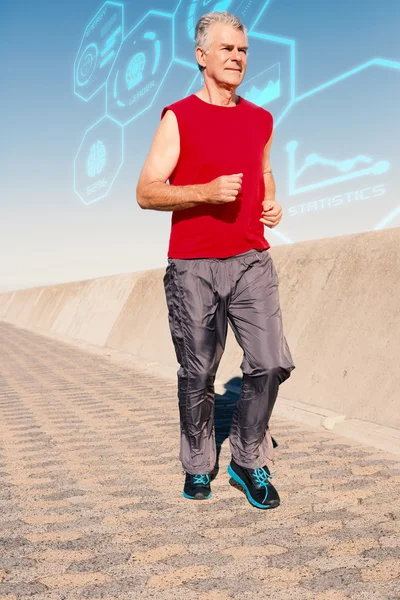 Active senior man jogging on the pier — Stock Photo, Image