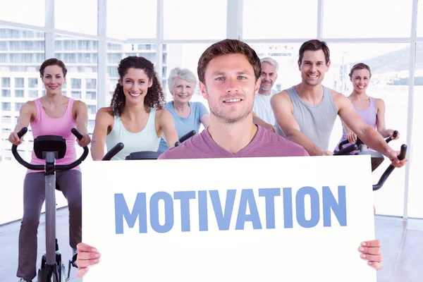 Man holding up a sign against motivation — Stock Photo, Image