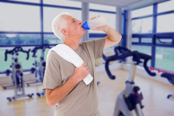 Senior man drinking from water bottle — Stock Photo, Image