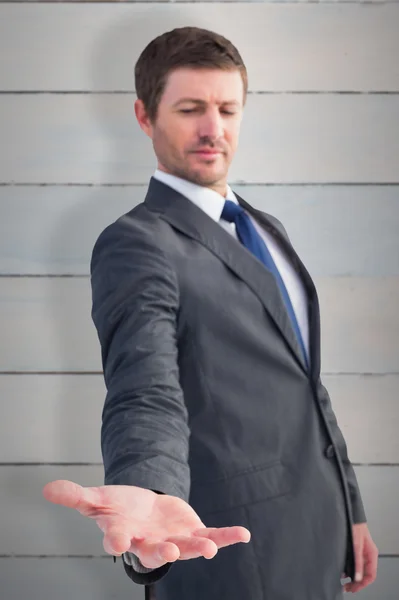 Businessman standing with hand out — Stock Photo, Image