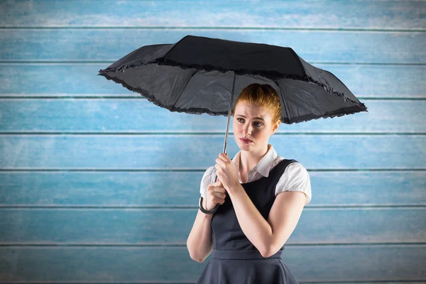 Redhead businesswoman holding umbrella — Stock Photo, Image