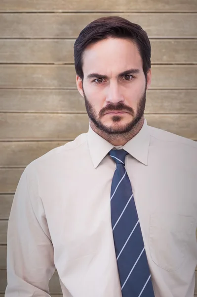 Angry businessman against wooden planks — Stock Photo, Image