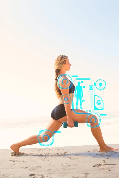 Fit blonde doing weighted lunges on the beach — Stock Photo, Image