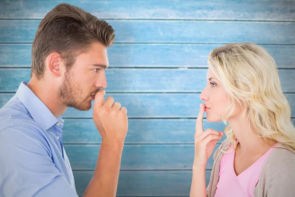 Couple staying silent with fingers on lips — Stock Photo, Image