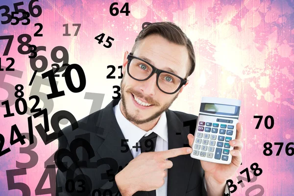 Geeky businessman pointing to calculator — Stock Photo, Image