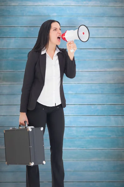 Businesswoman shouting with megaphone — Stock Photo, Image