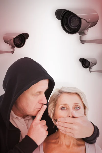 Older man silencing his fearful partner — Stock Photo, Image