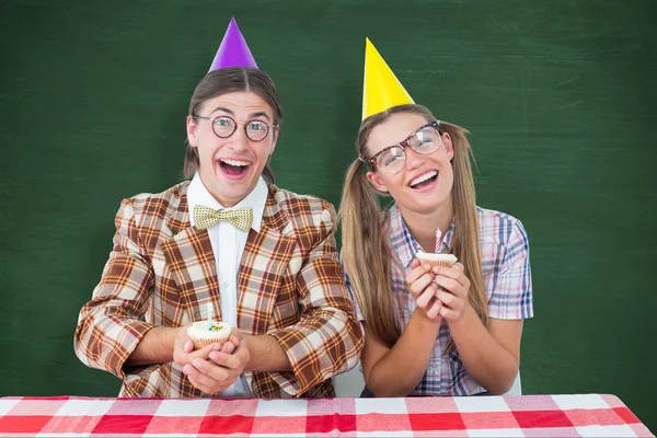 Composite image of geeky hipsters celebrating birthday — Stock Photo, Image