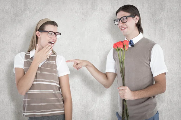 Geeky hipster offering red roses — Stock Photo, Image