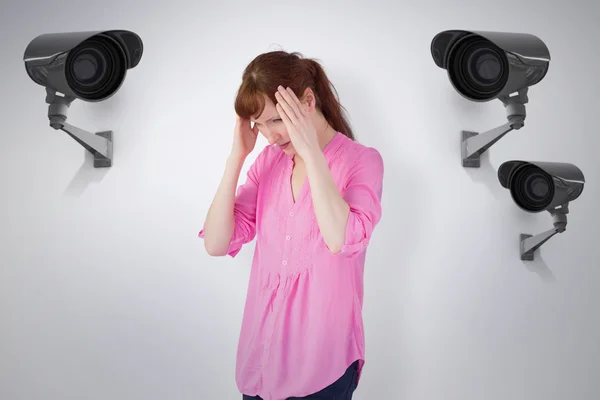 Worried redhead against cctv camera — Stock Photo, Image