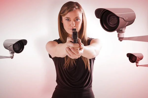 Femme fatale pointing gun at camera — Stock Photo, Image