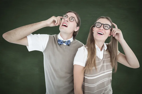 Composite image of geeky hipsters looking confused — Stock Photo, Image