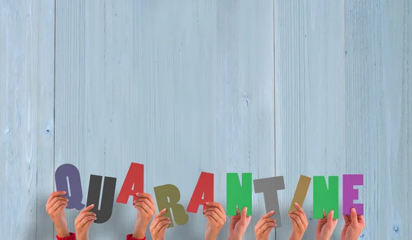 Composite image of hands holding up quarantine — Stock Photo, Image