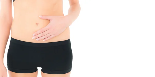 Closeup mid section of a fit woman with stomach pain — Stock Photo, Image