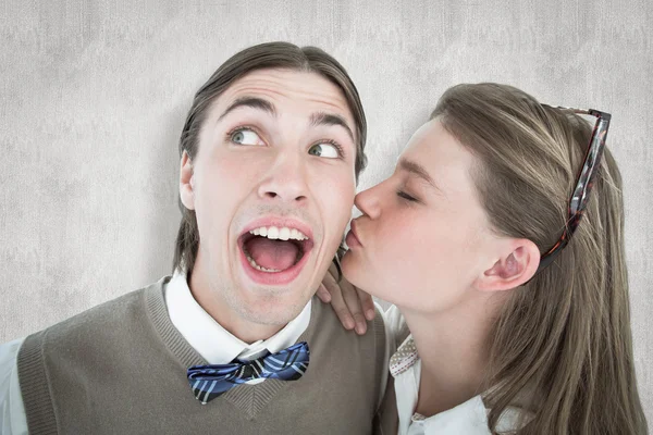 Composite image of pretty geeky hipster giving boyfriend kiss on — Stock Photo, Image