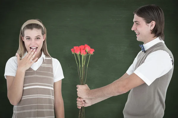 Geeky hipster offering red roses — Stock Photo, Image