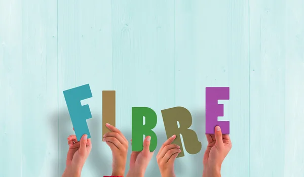 Composite image of hands holding up fibre — Stock Photo, Image