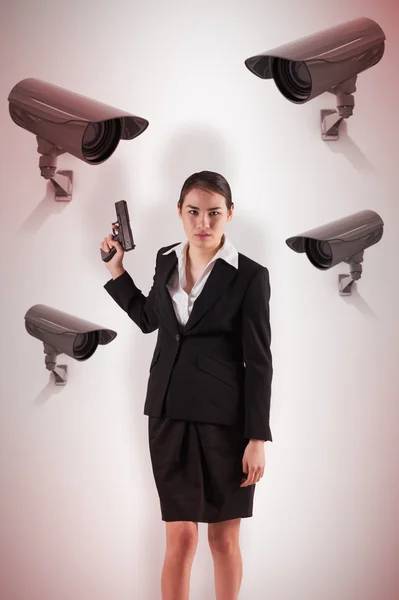 Businesswoman holding a gun — Stock Photo, Image