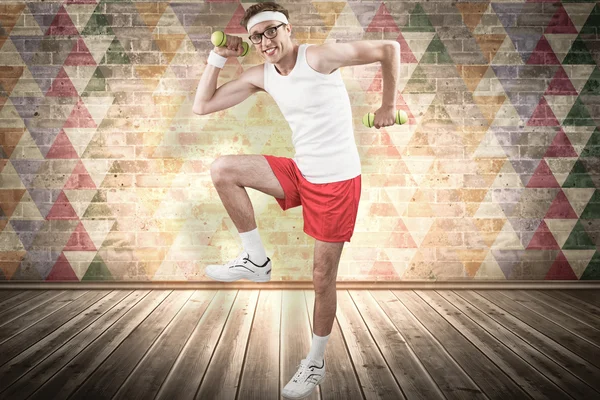 Geeky hipster posing in sportswear with dumbbells — Stock Photo, Image