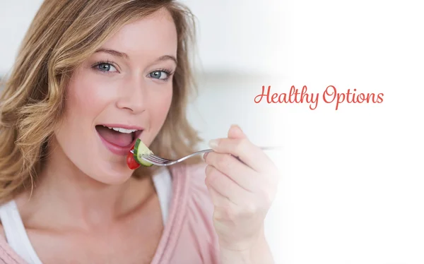 Woman eating salad with fork — Stock Photo, Image
