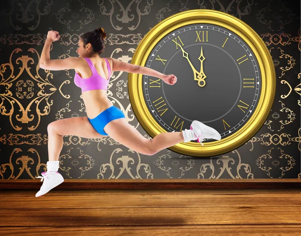 Fit brunette running and jumping — Stock Photo, Image