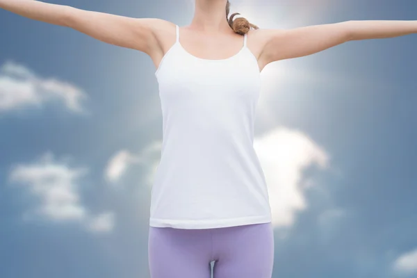 Woman standing with arms raised on countrysid Stock Image