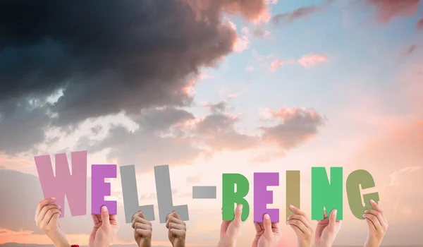 Composite image of hands holding up well being — Stock Photo, Image