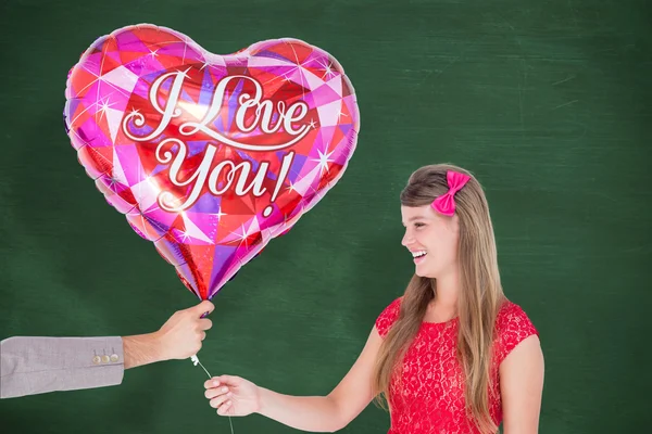 Geeky hipster offering red heart shape balloon — Stock Photo, Image