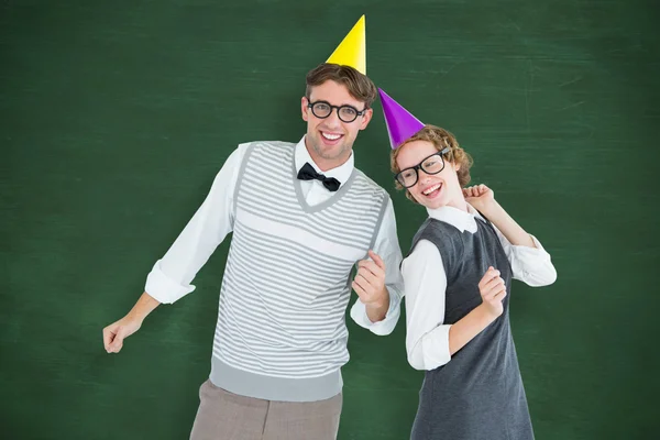 Geeky hipster couple wearing a party hat — Stock Photo, Image