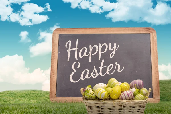 Composite image of easter eggs in basket — Stock Photo, Image