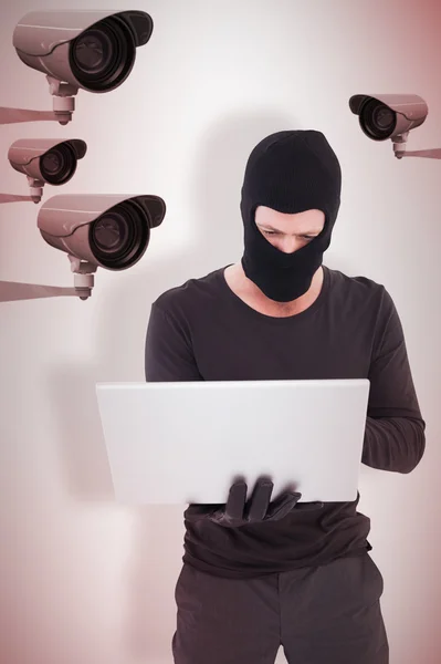 Hacker using laptop to steal identity — Stock Photo, Image