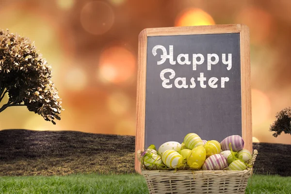 Composite image of easter eggs in basket — Stock Photo, Image
