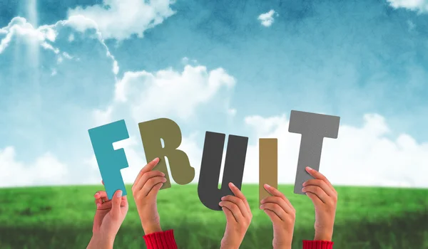 Composite image of hands holding up fruit — Stock Photo, Image