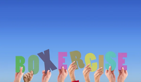 Composite image of hands holding up boxercise — Stock Photo, Image