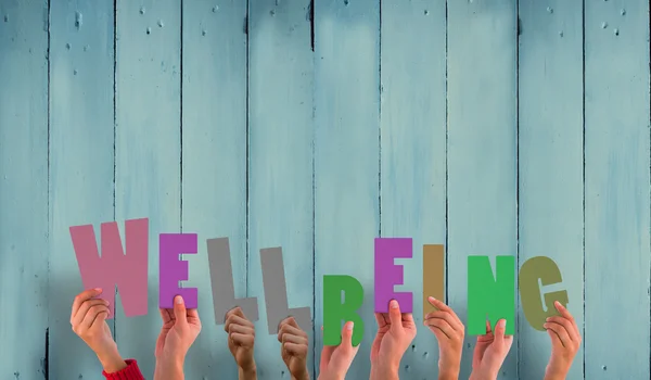 Composite image of hands holding up well being — Stock Photo, Image