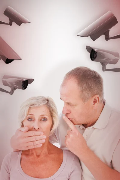 Man silencing his fearful partner — Stock Photo, Image