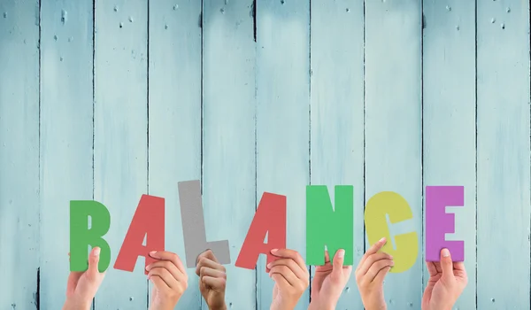 Composite image of hands holding up balance — Stock Photo, Image