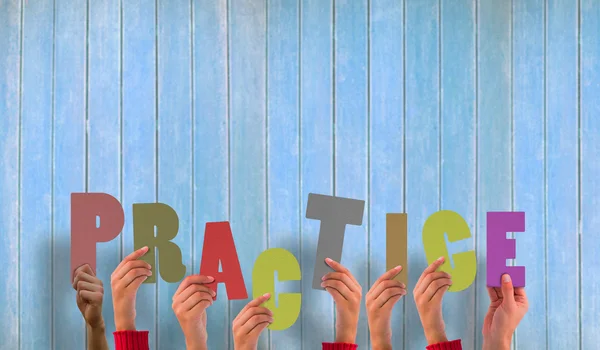 Composite image of hands holding up practice — Stock Photo, Image