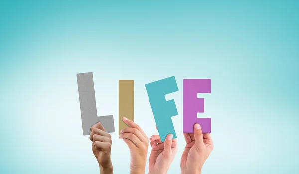 Composite image of hands holding up life — Stock Photo, Image