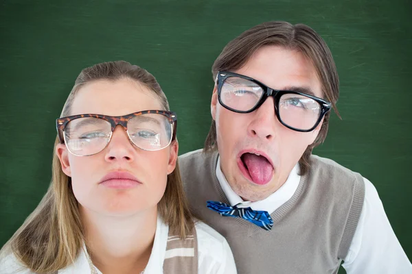 Composite image of funny geeky hipsters grimacing — Stock Photo, Image