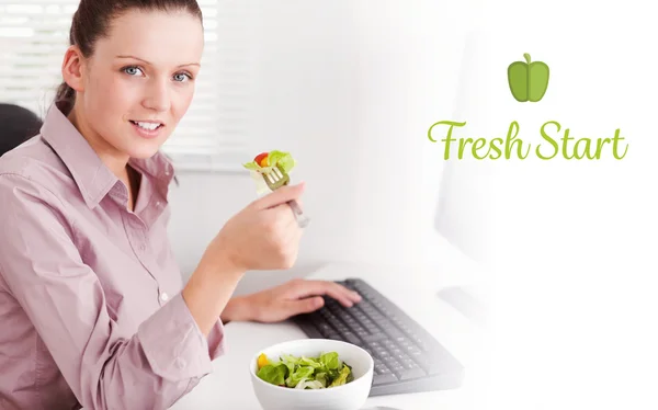 Fresh start against businesswoman in office eating salad — Stock Photo, Image