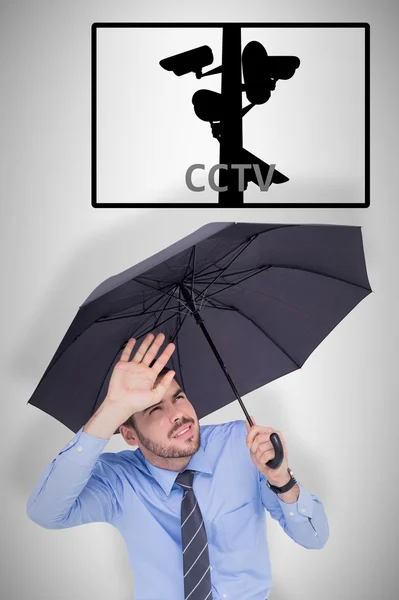 Businessman protecting his eyes with hand — Stock Photo, Image