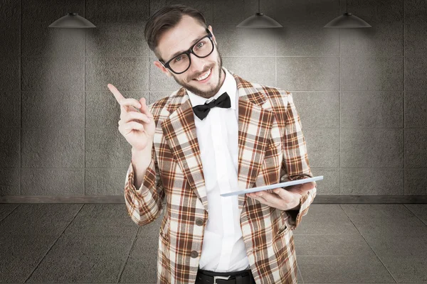 Geeky hipster holding a tablet pc — Stock Photo, Image