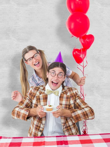Composite image of geeky hipsters celebrating birthday — Stock Photo, Image